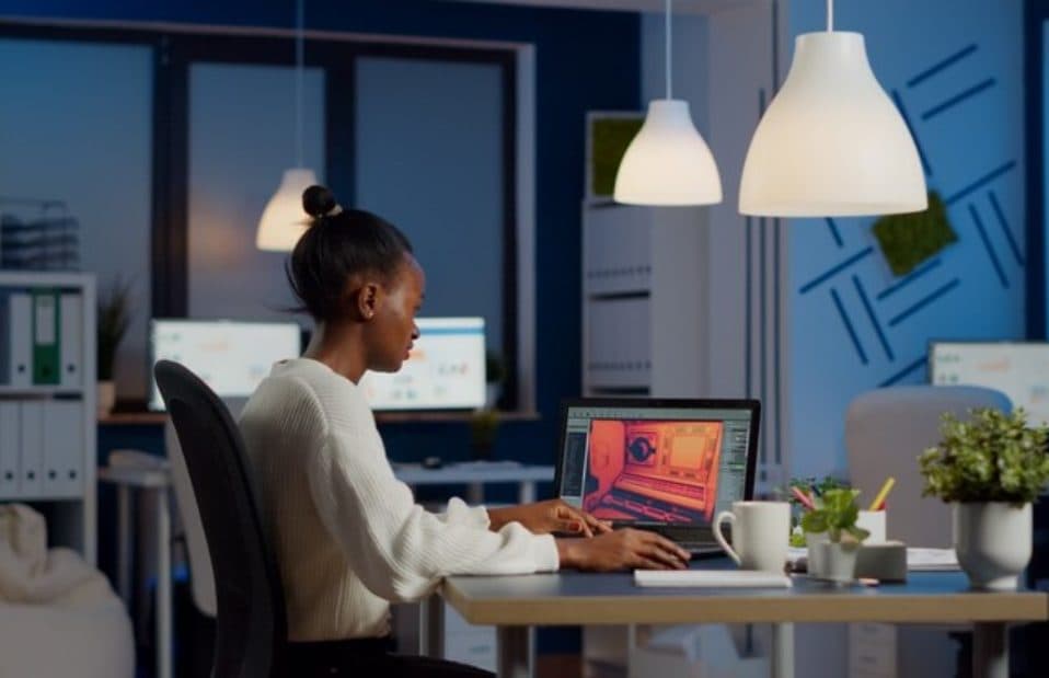 A professional working on a laptop in a modern office